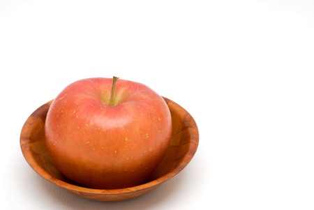 Red apple on the wood plate