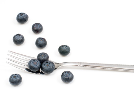 Blueberry and fork on a white background
