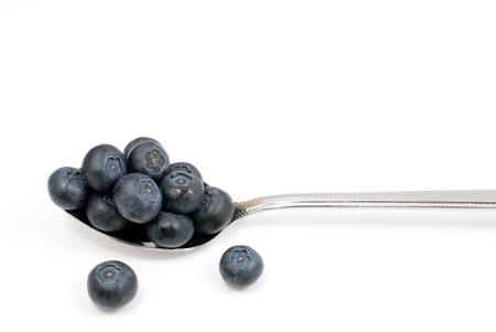 Blueberry and spoon on a white backgroundの写真素材