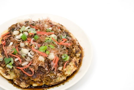 Japanese wheat flour pancake with various ingredients called Okonomiyakiの写真素材