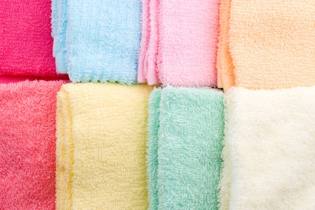 Background and texture of eight multi color towels laid side by sideの写真素材