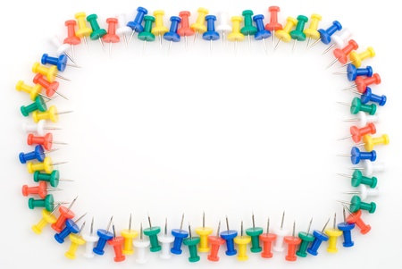 Frame of many colored drawing pins on a white backgroundの写真素材
