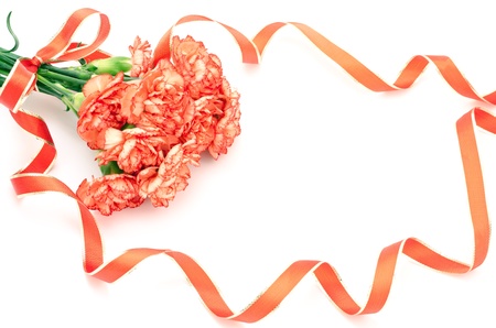 Orange carnations bouquet tied with a ribbon on white backgroundの写真素材