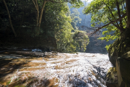 River over the rock mass which flows down a cliffの写真素材