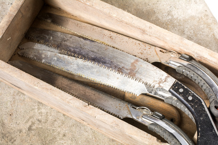 Worn out saws in the wooden box