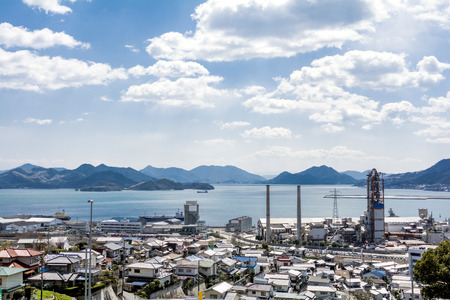 Seashore view of Mihara city under sky with cloudsの写真素材