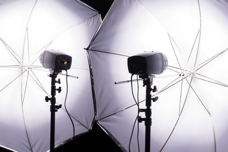 Two monoblock flashes flashing with light reflected umbrella