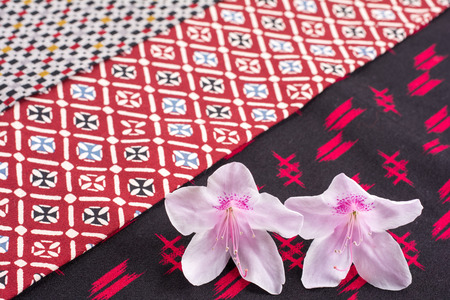 Pale pink azalea flowers on old japanese cloth