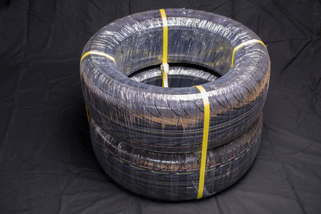 Two packing automobile tires on black clothの写真素材