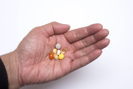 Colorful various medicine on the palm in fornt of white background