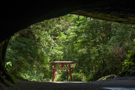 Gateway to a sacred space Torii from inside the caveの写真素材