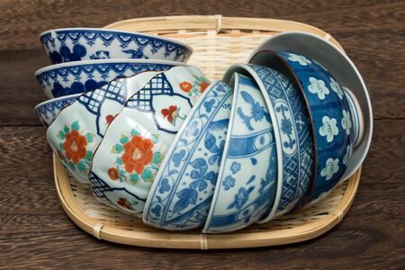 Lying various pottery bowls on the bamboo colander