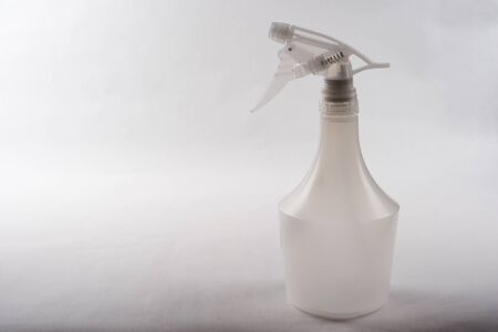 Plastic spray bottle in front of gray backgroundの写真素材