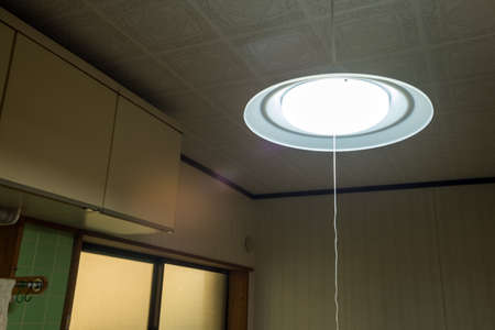 Illuminated LED pendant light hanging in the kitchenの写真素材