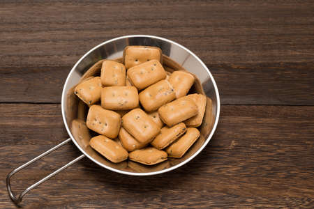 Hardtacks in a sierra cup on the wooden tableの写真素材