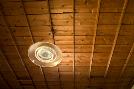 Pendant lighting hanging from the ceiling of an old wooden houseの写真素材
