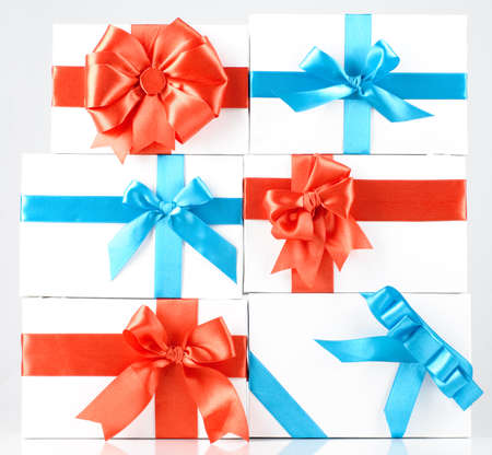 boxes with red and blue ribbons on whiteの写真素材