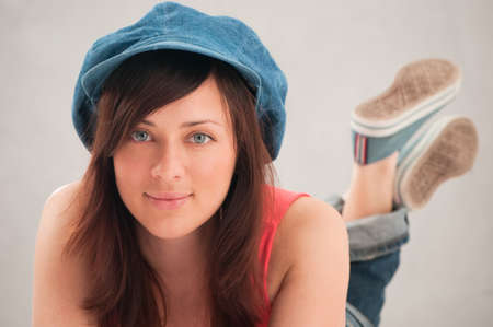 portrait young attractive woman with blue capの写真素材