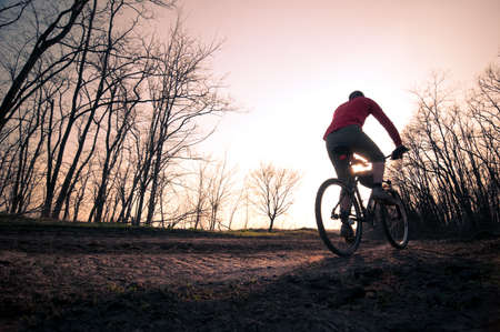 man extreme biking at sunsetの写真素材