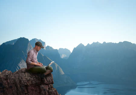 man working outdoors with laptopの写真素材