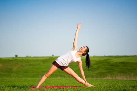 woman doing yoga outdoorsの写真素材