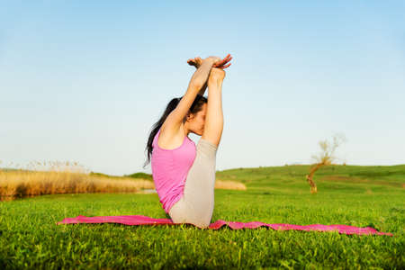 woman doing yoga outdoorsの写真素材