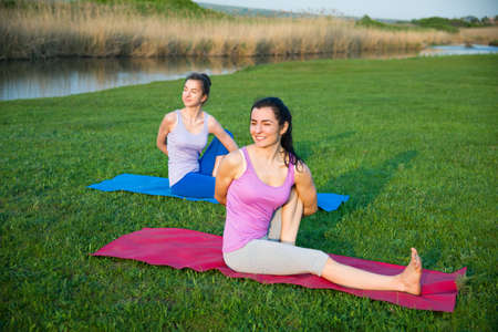 couple doing yoga outdoors