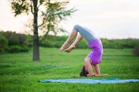 woman doing yoga outdoorsの写真素材