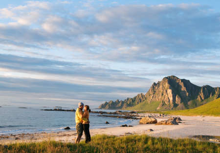 couple walking around beach in Norwayの写真素材