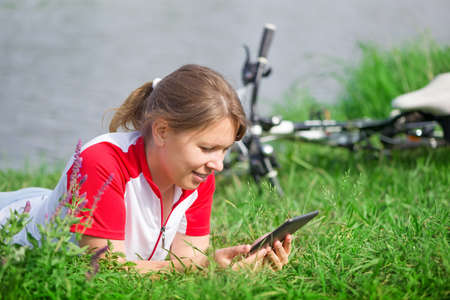 young woman using tablet PC outdoorsの写真素材