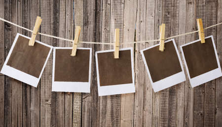 old prints hanging on ropeの写真素材