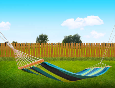 Relaxing on hammock in backyardの写真素材