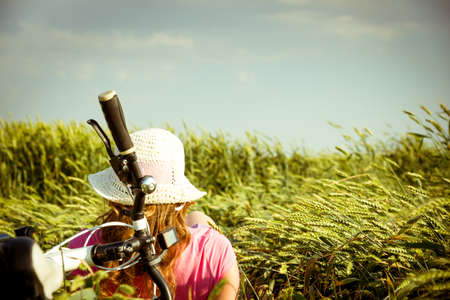 woman cycling countryside in summerの写真素材
