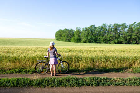 woman cycling countryside in summerの写真素材