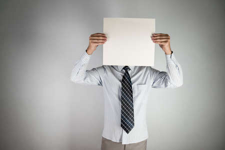 unknown person man hiding his faceの写真素材