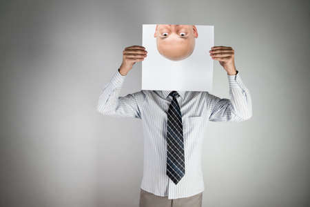 unknown person man hiding his faceの写真素材