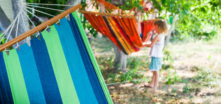 child with hammock in backyard at summerの写真素材