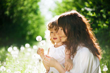 daughter with her mother together outdoorsの写真素材