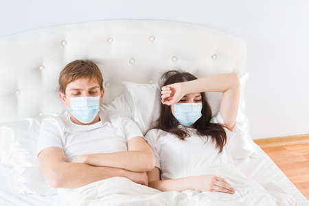 couple in bed suffering common coldの写真素材
