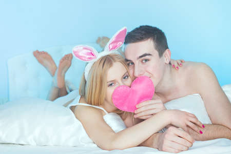 happy young couple in bedの写真素材