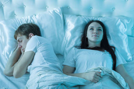 couple sleeping in bedの写真素材
