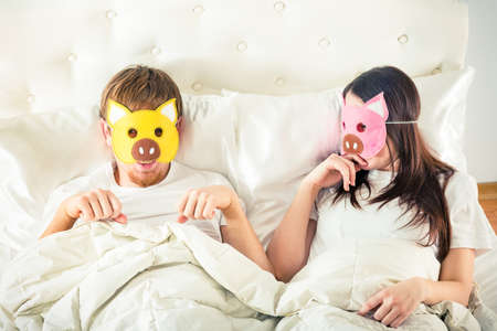 playful couple in bedの写真素材