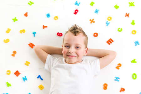 smiling boy lying on floorの写真素材