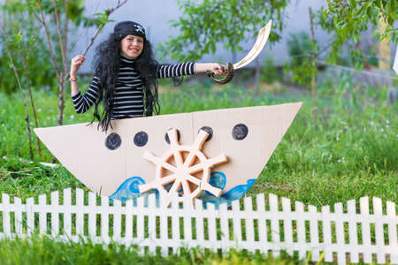 kid playing pirates at backyardの写真素材
