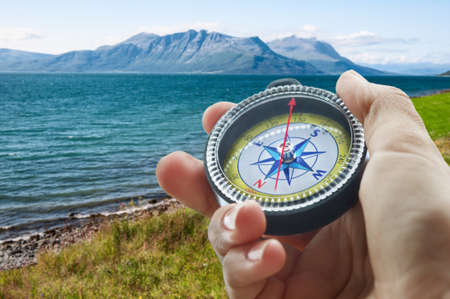 compass and hand in mountainsの写真素材