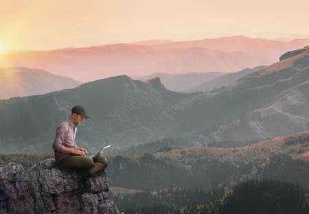 man working outdoors with laptopの写真素材