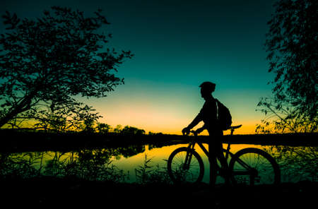 silhouette of biker at sunsetの写真素材