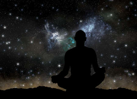 silhouette of man practicing yoga at cosmos backgroundの写真素材