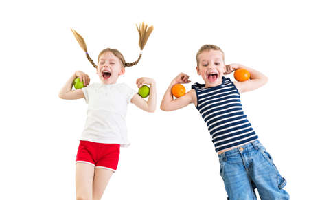 kids with apples and oranges, healthy nutrition conceptの写真素材