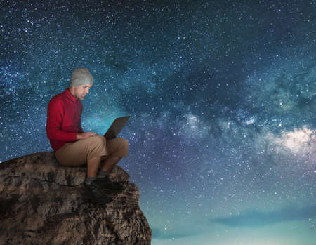 man working wireless outdoors with laptop